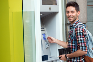 Young man using the ATM